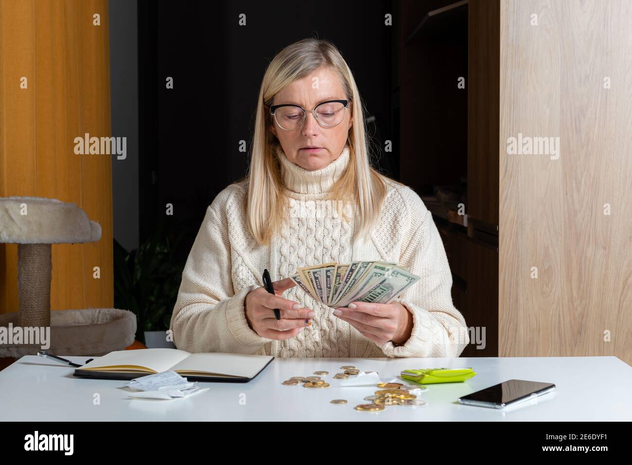 emotional freelance woman calculating budget in home office, expense