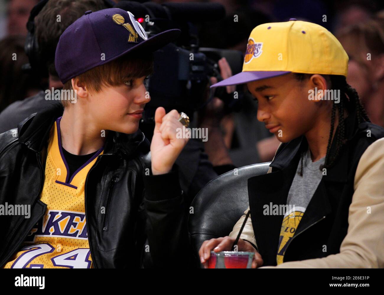 Singer Justin Bieber of Canada (L) shows actor Jaden Smith an NBA  Championship ring belonging to Los Angeles Lakers executive vice president  Jeanie Buss during the NBA game between the Los Angeles