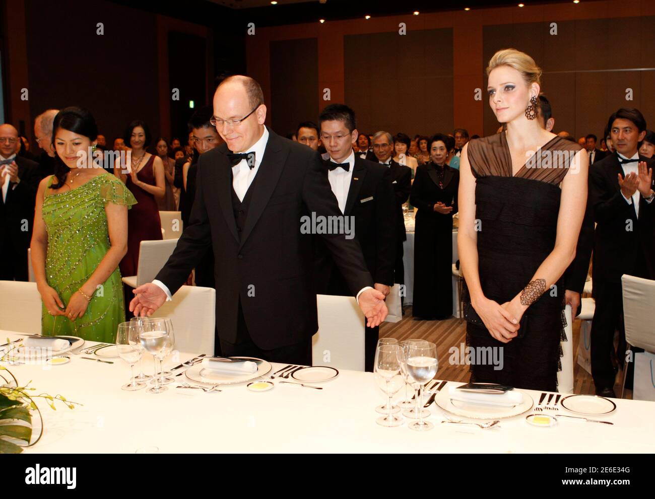 RPA ONLY : Monaco's Prince Albert II (C) and his fiancee Charlene Wittstock (R) arrive at a gala dinner hosted by BirdLife International in Tokyo October 29, 2010. REUTERS/Issei Kato (JAPAN - Tags: ROYALS SOCIETY) Stock Photo