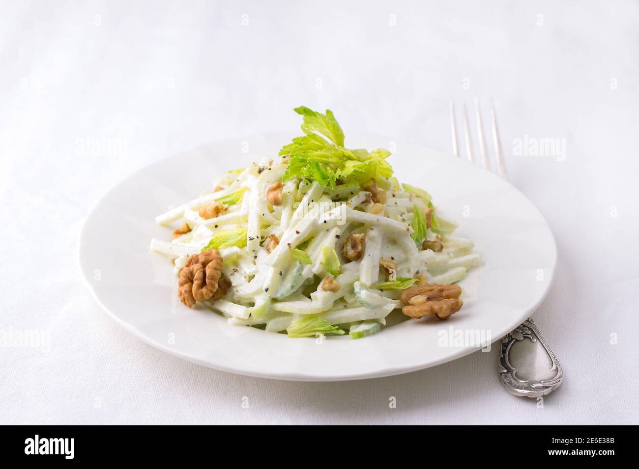 Traditional Waldorf salad with celery, apple, walnut and yoghurt dressing on white background, selective focus, horizontal Stock Photo