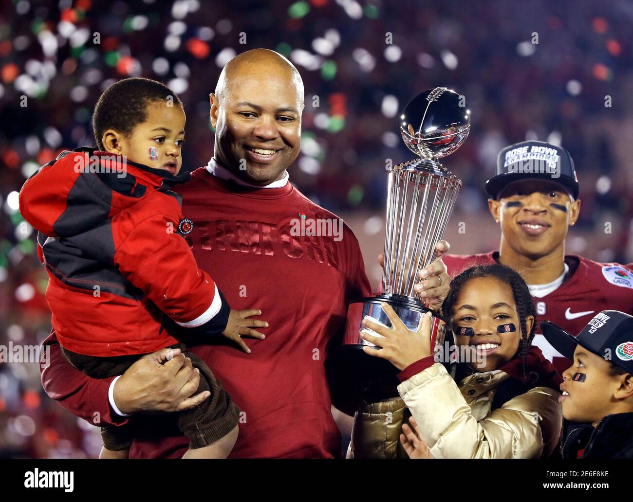 Stanford Cardinal head coach David Shaw holds up the Rose Bowl trophy with  his children after defeating the Wisconsin Badgers to win the 99th Rose Bowl  Game in Pasadena, California January 1,