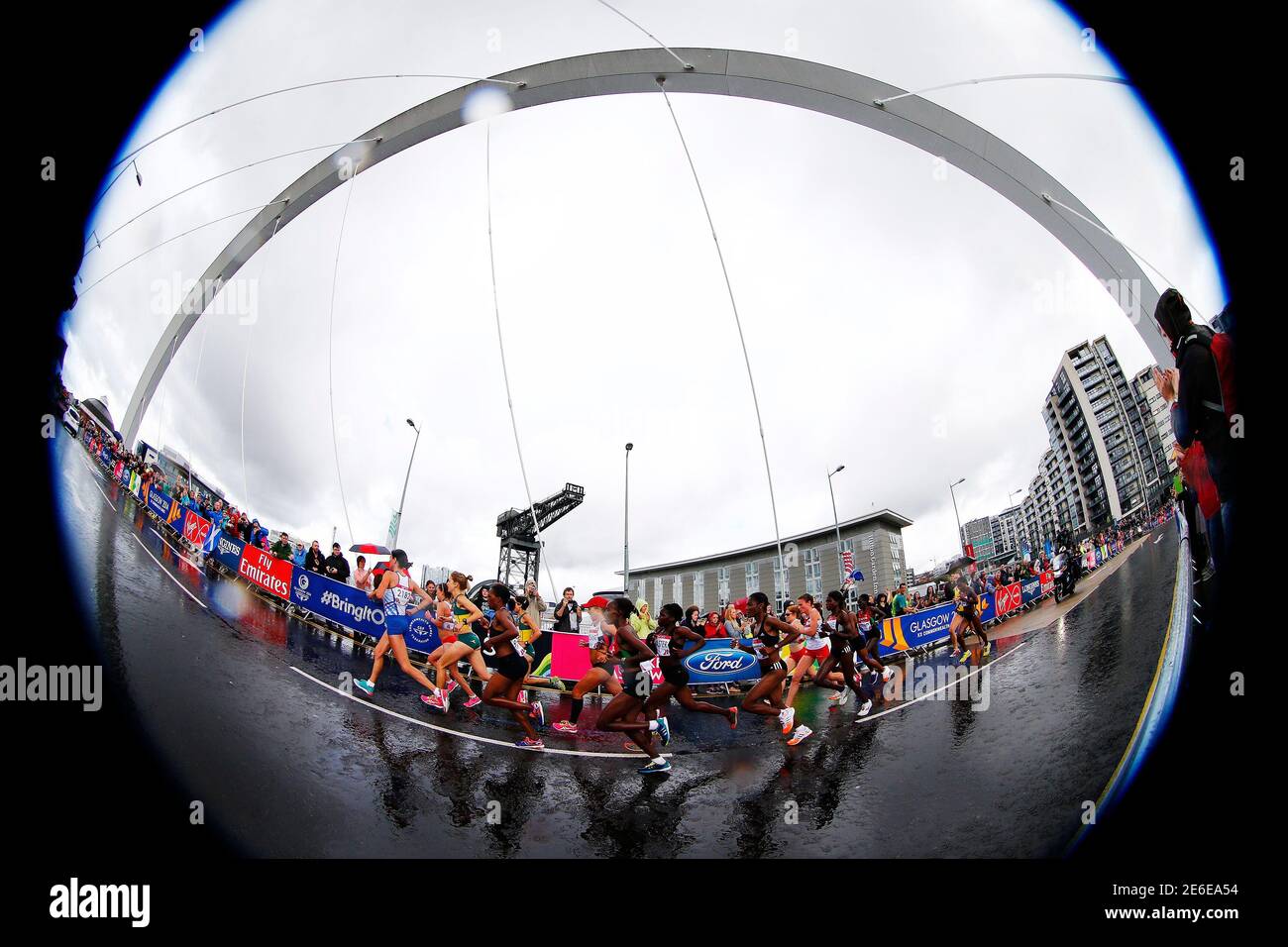 The elite women's marathon runners cross the Clyde Arc Bridge, known  locally as the "Squinty Bridge" during the 2014 Commonwealth Games in  Glasgow, Scotland, July 27, 2014. Picture taken with a fish-eye