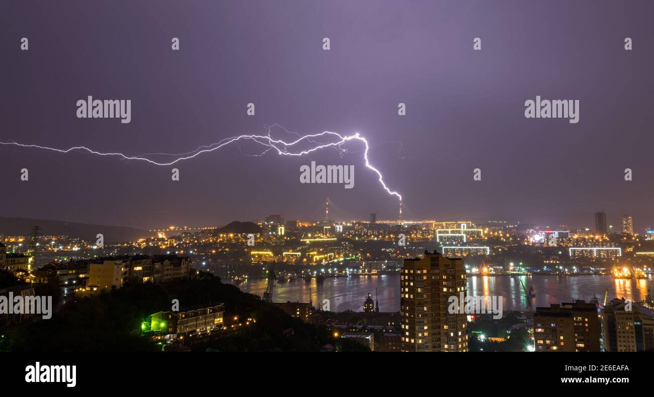 Lightning storm over night city Stock Photo - Alamy