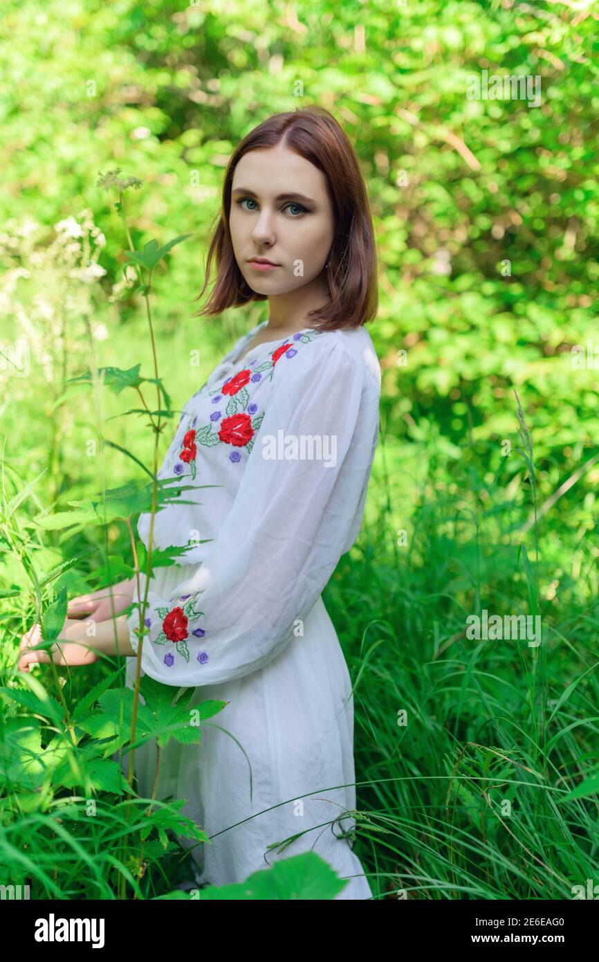 Outdoors portrait of beautiful young woman in the park. Selective focus ...