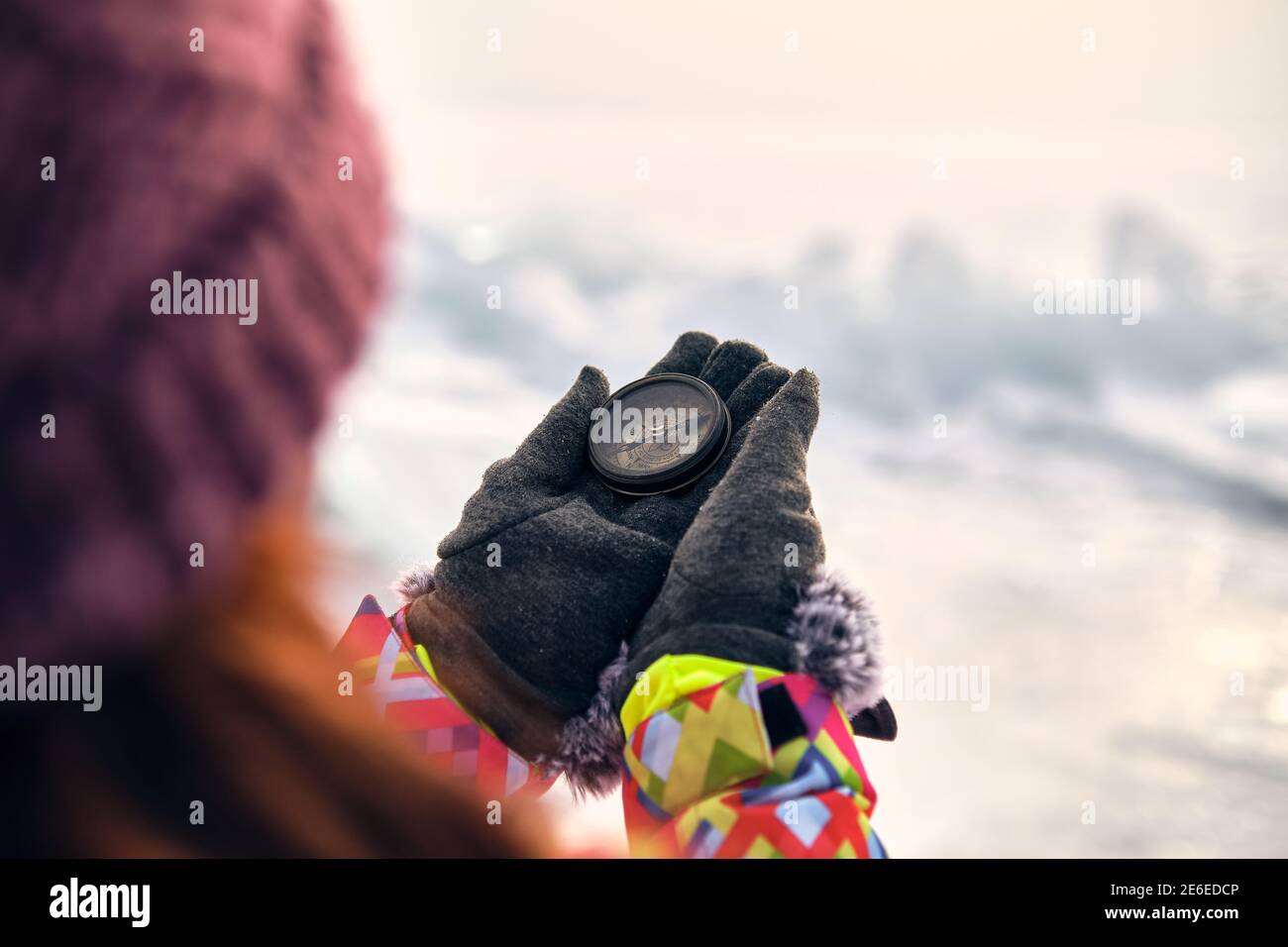 Hiker Hand Holding A Compass And Ices In Background Stock Photo