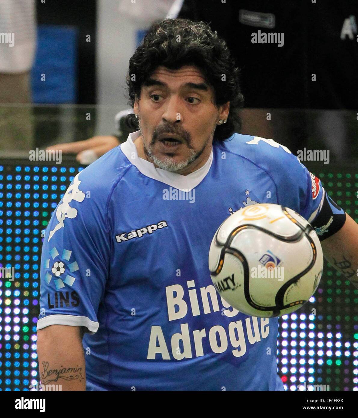 Former Argentina's national soccer team coach Diego Maradona prepares to  kick the ball during a charity match for ex-soccer player Fernando Caceres  in Buenos Aires October 16, 2010. Caceres was attacked in
