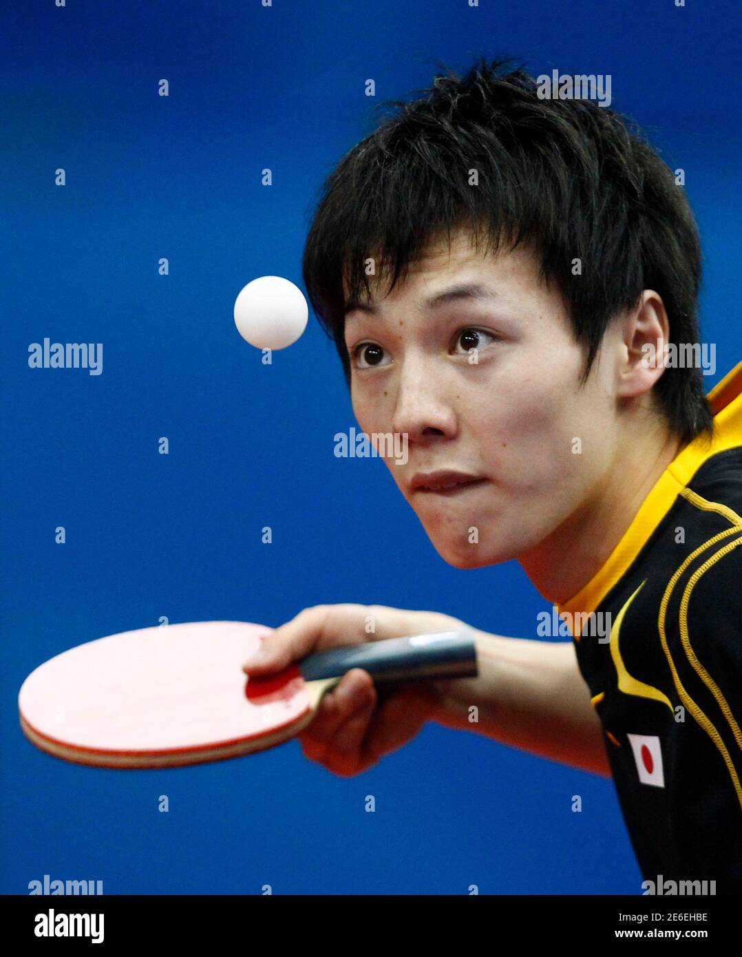 Kenta Matsudaira of Japan eyes the ball as he serves during his men's doubles table tennis match against China's Ma Lin and Xu Xin at the 16th Asian Games in Guangzhou, Guangdong province, November 19, 2010. REUTERS/Jason Lee (CHINA  - Tags: SPORT TABLE TENNIS) Stock Photo