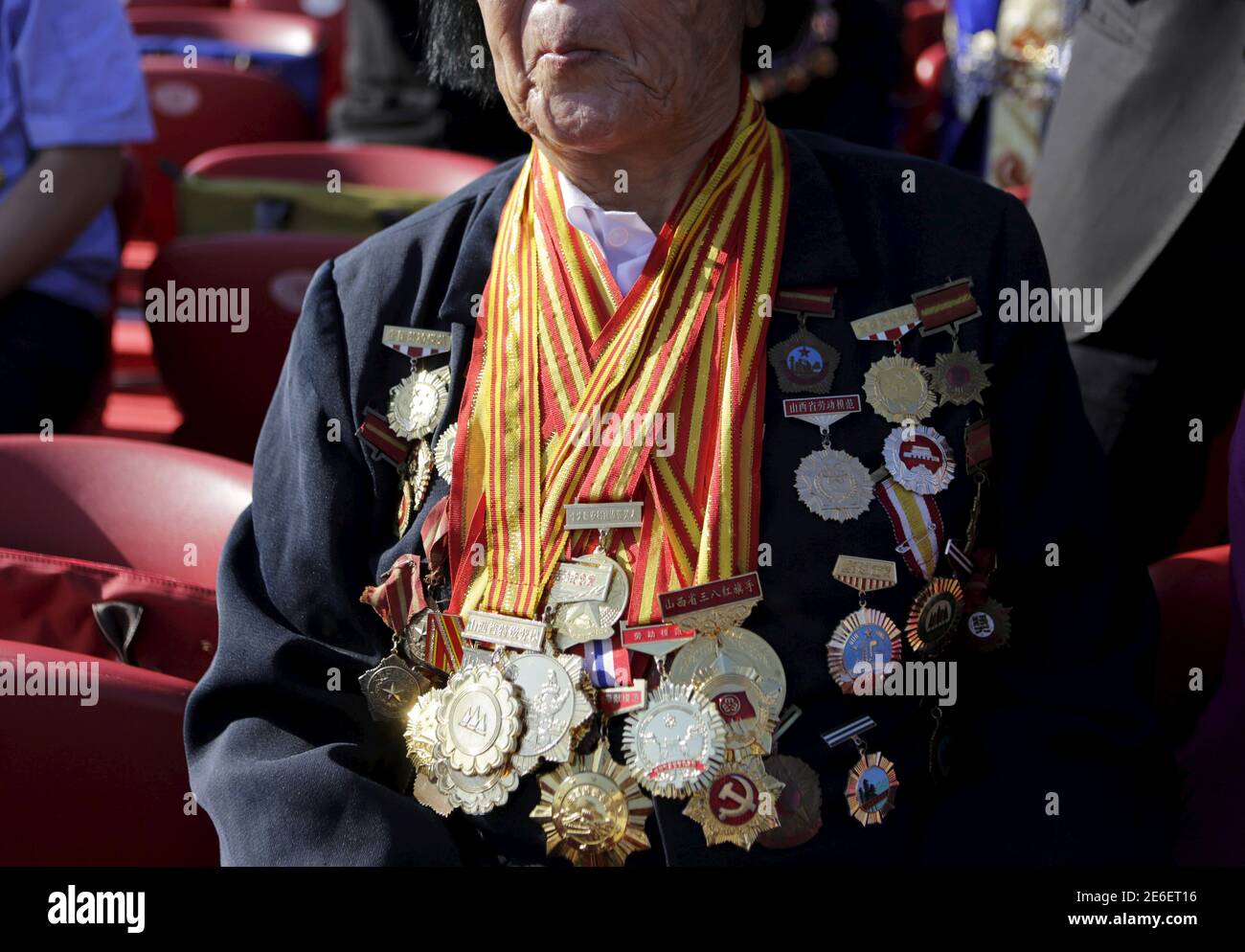 Shen Jilan wearing insignias and medals sits, ahead of the military parade to mark the 70th anniversary of the end of World War Two, in Beijing, China, September 3, 2015. Shen, 85, is the only person in China to be elected 12 consecutive times as a member of China's parliament, after she was appointed to China's first National People's Congress (NPC) in 1954, according to local media. REUTERS/Jason Lee Stock Photo