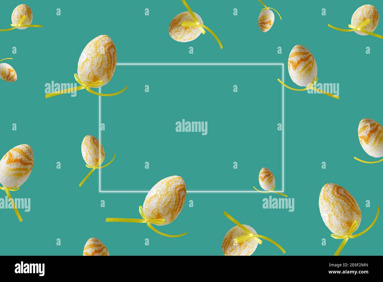 Spring pattern with flying yellow eggs on turquoise background. Zero gravity concept. Hello spring, frame for text. Stock Photo