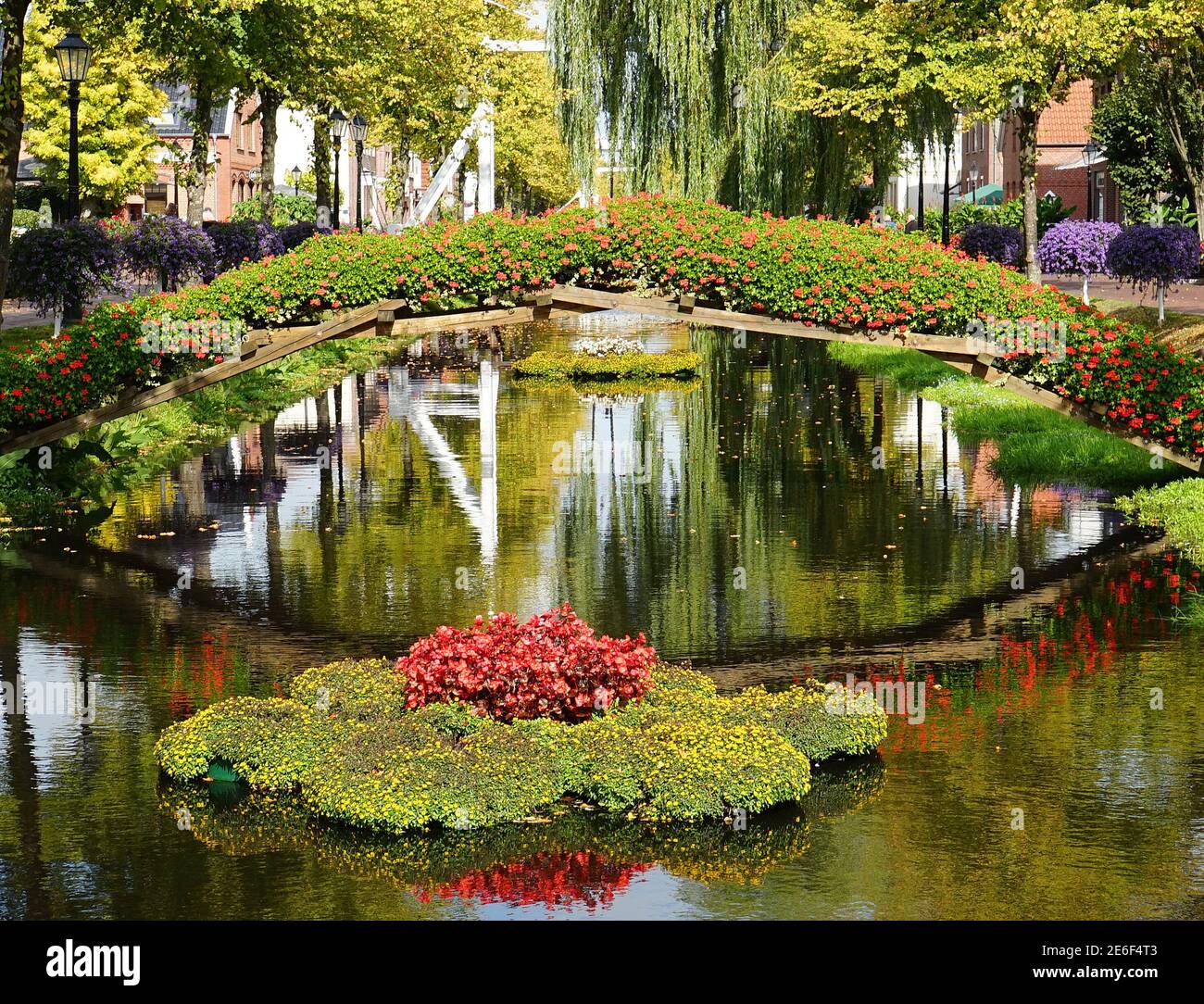 A kind of flower bridge has been built across the canal. A flower