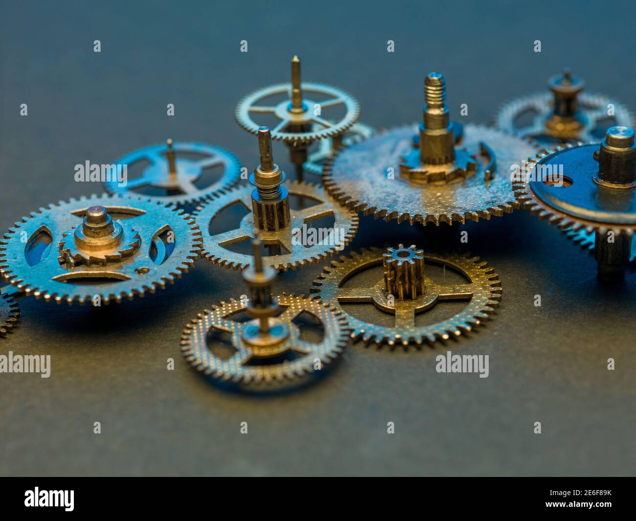 Close view on golden cogs and wheels on blue background Stock Photo