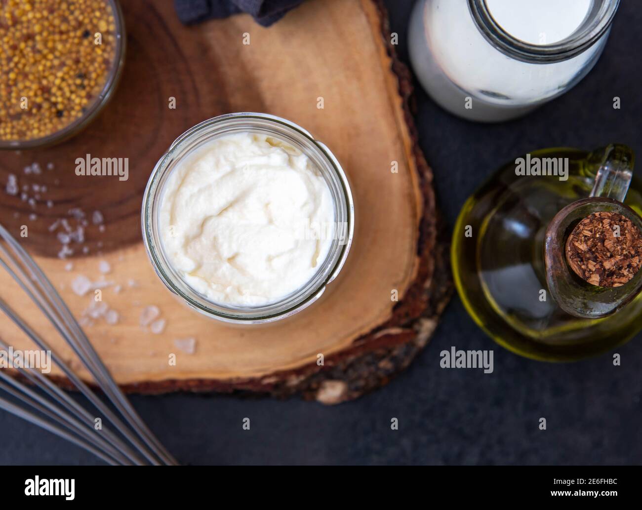 Vegetarian mayonnaise. Ingredients for mayonnaise oil, milk and mustard. Homemade mayonnaise