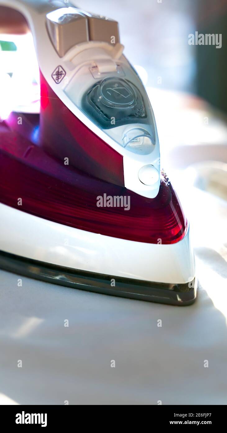 Close up of a steam iron on an ironing board Stock Photo Alamy