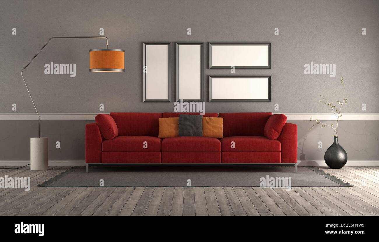 Living room with modern red sofa, empty picture frame and floor lamp - 3d rendering Stock Photo