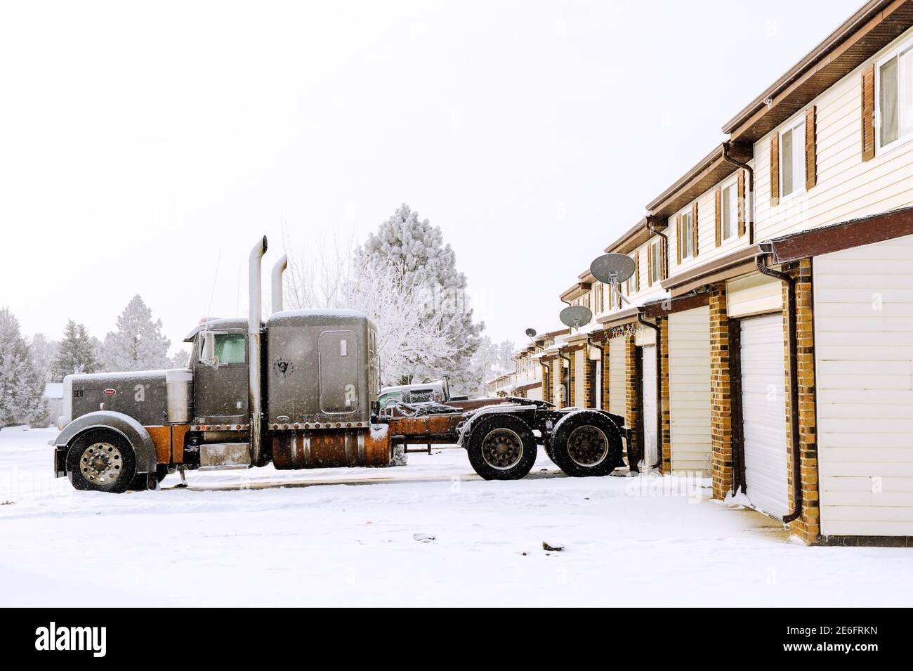 A truck sits idle outside an apartment in Dickinson, North Dakota January 21, 2016. As oil prices continue downward, truck drivers and other oil field workers in North Dakota's Bakken shale play have lots their jobs or seen their hours reduced. The collapse of U.S. oil and gas investment could have further to fall and Americans are showing signs they spend less of their windfall from lower gasoline prices than in the past, darkening the outlook for the U.S. economy. REUTERS/Andrew Cullen Stock Photo