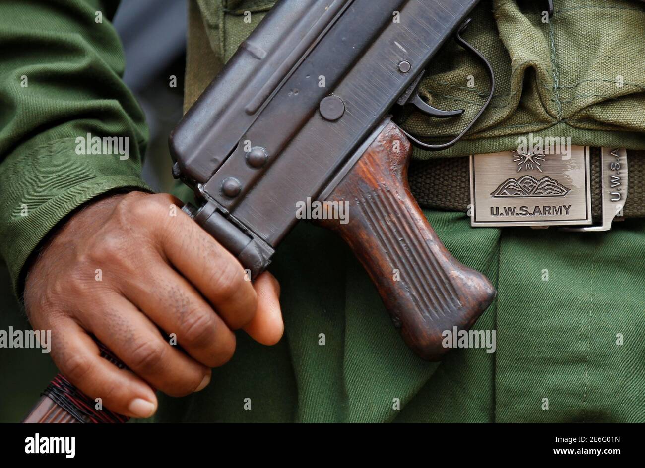 United Wa State Army (UWSA) soldier holds a weapon as he marches during a  festival in a village outside Pansang, Wa territory in northeast Myanmar  October 3, 2016. Picture taken on October
