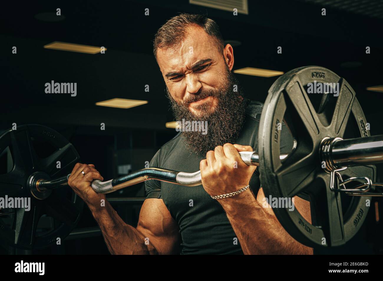 Powerlifter with strong arms lifting barbell in a gym Stock Photo Alamy