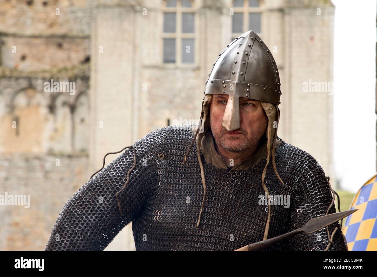 12th century soldier keeping warm by brazier outside 12th century castle Stock Photo