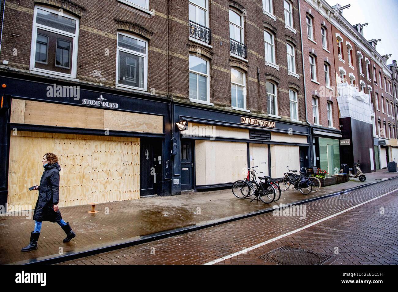 Shopkeepers have barricaded and boarded up their business in Amsterdam,  Netherlands on January 28, 2021. The entrepreneurs in the chic shopping  street fear damage if riots break out. Most of the stores