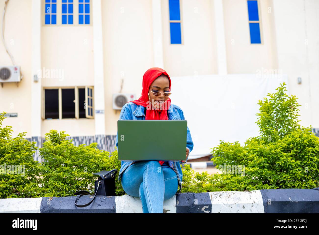 young black beautiful lady sitting out and working on her laptop Stock ...