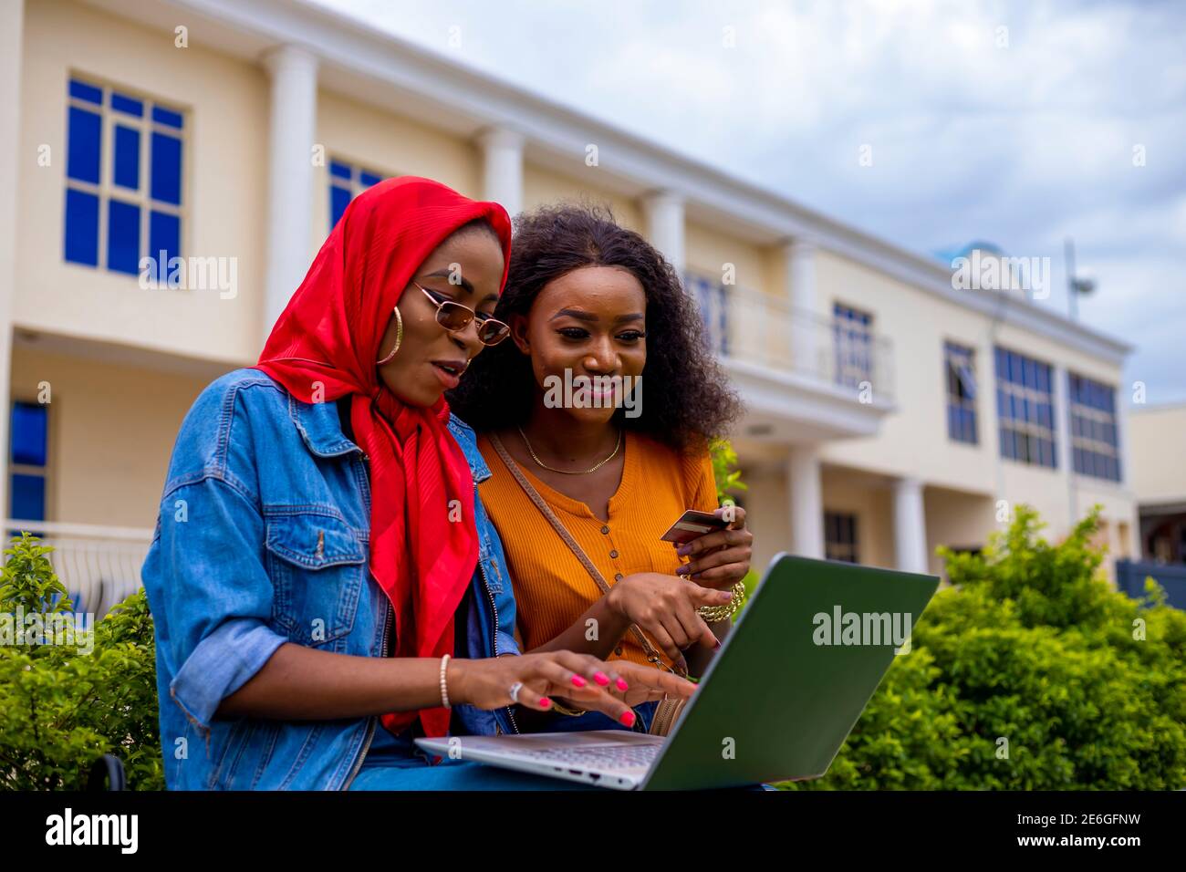 young black beautiful ladies sitting out and working on her laptop ...