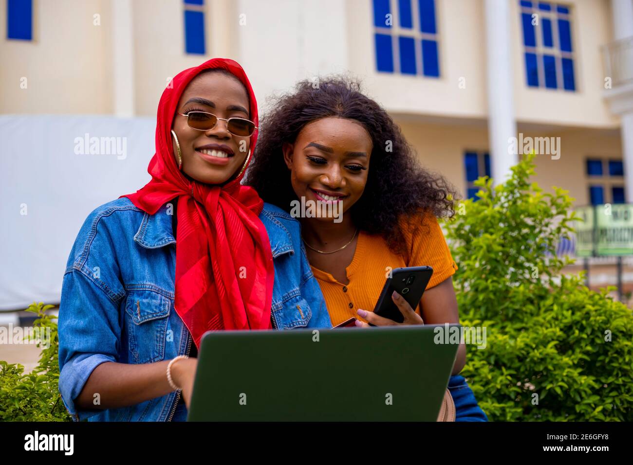young black beautiful ladies sitting out and working on her laptop ...