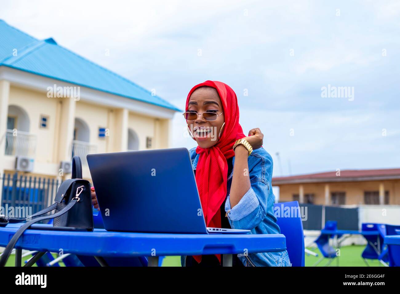 young black beautiful lady sitting out and working on her laptop Stock ...