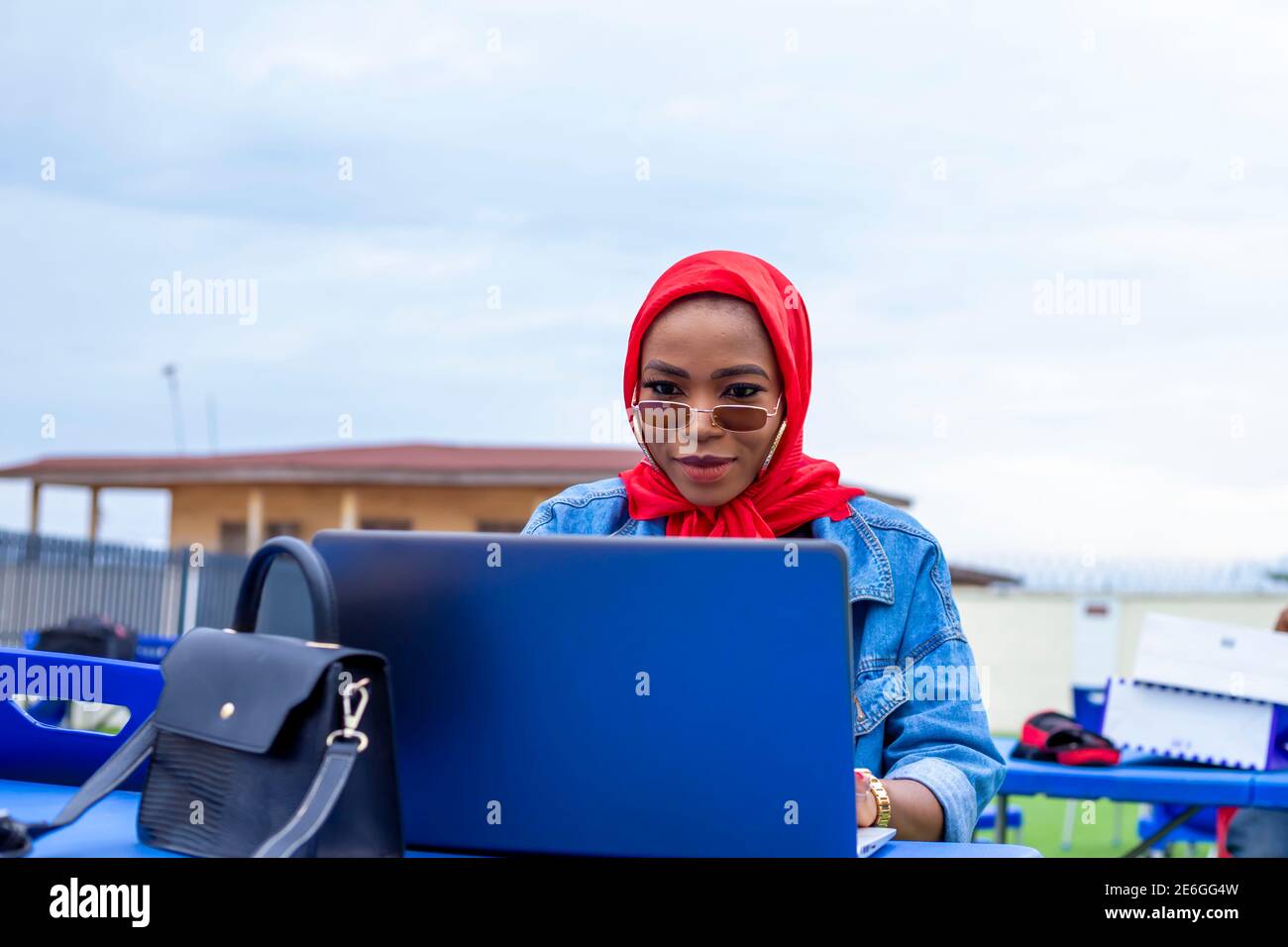 young black beautiful lady sitting out and working on her laptop Stock ...