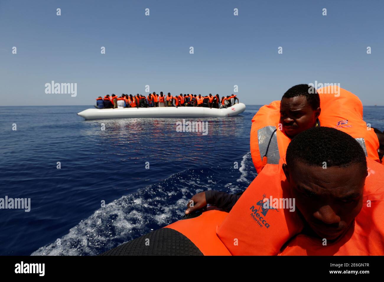 Migrants react after being rescued by the Malta-based NGO Migrant Offshore  Aid Station (MOAS) ship Phoenix during a rescue operation in the central  Mediterranean, in international waters off the Libyan coastal town