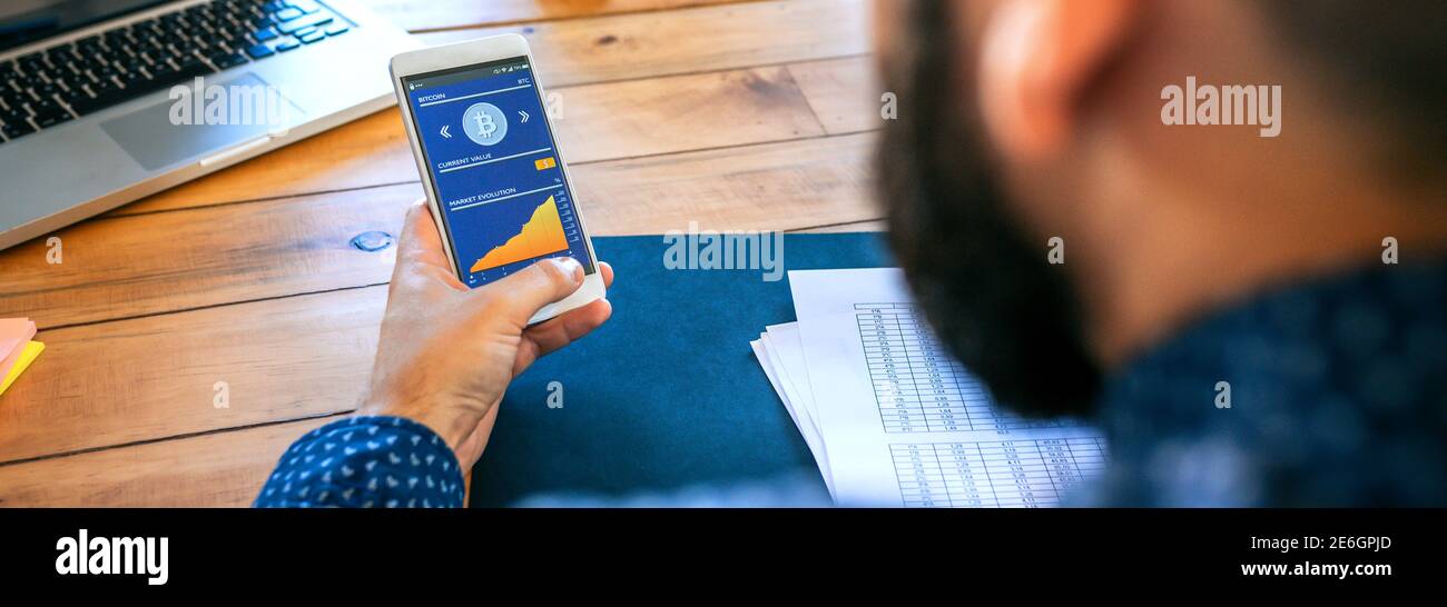 Businessman looking mobile with bitcoins information Stock Photo