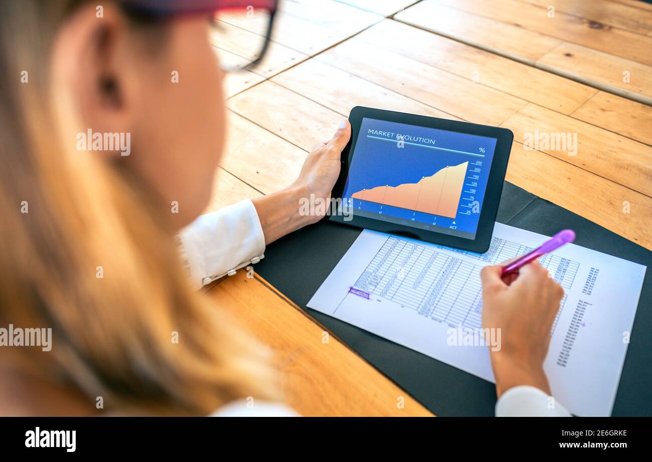 Businesswoman analyzing market evolution with tablet Stock Photo