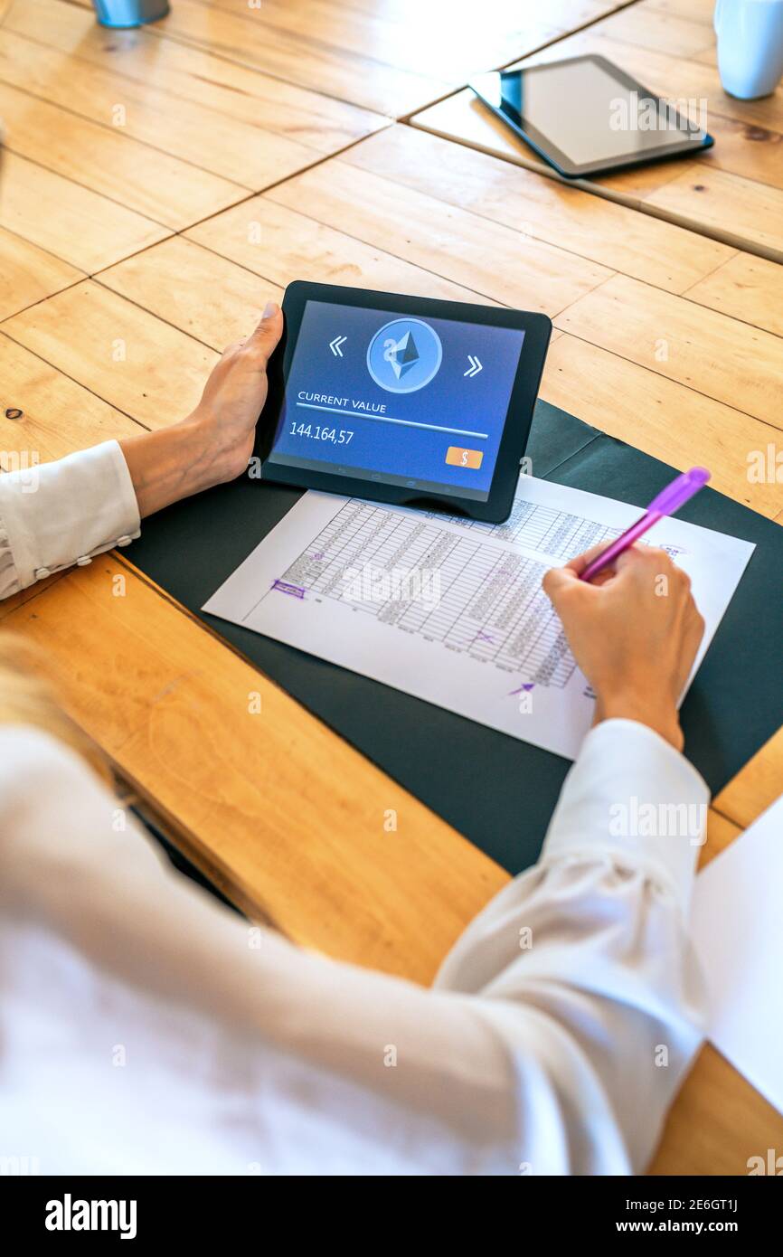 Businesswoman with tablet with ethereum information working Stock Photo