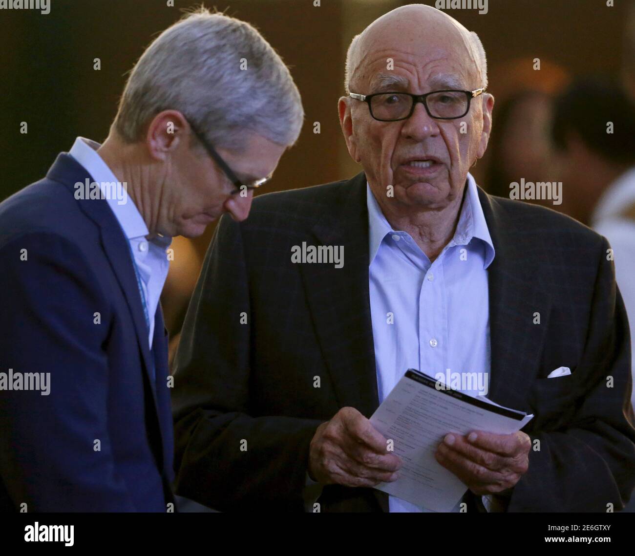 Apple CEO Tim Cook (L) talks with News Corp Executive Chairman Rupert Murdoch before sitting down to dinner at the  Wall Street Journal Digital Live ( WSJDLive ) conference at the Montage hotline Laguna Beach, California   October 19, 2015.      REUTERS/Mike Blake Stock Photo