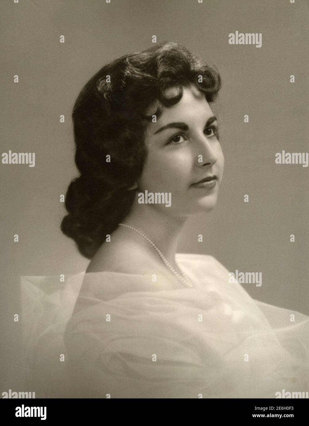 Portrait of young brunette woman with pearl necklace, 1957 Stock Photo ...