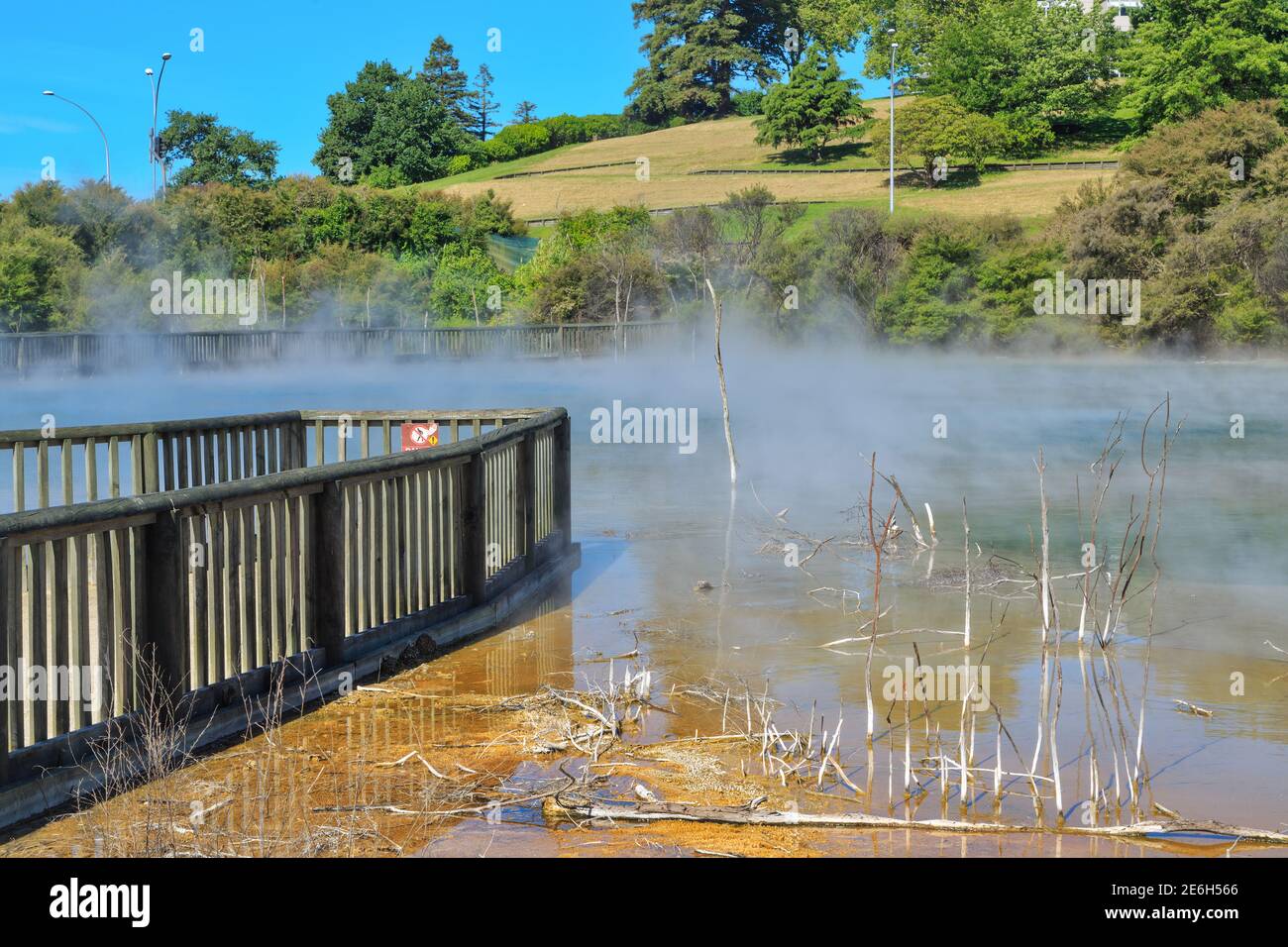 A wooden viewing platform by a steaming hot geothermal lake in Kuirau Park, Rotorua, New Zealand Stock Photo