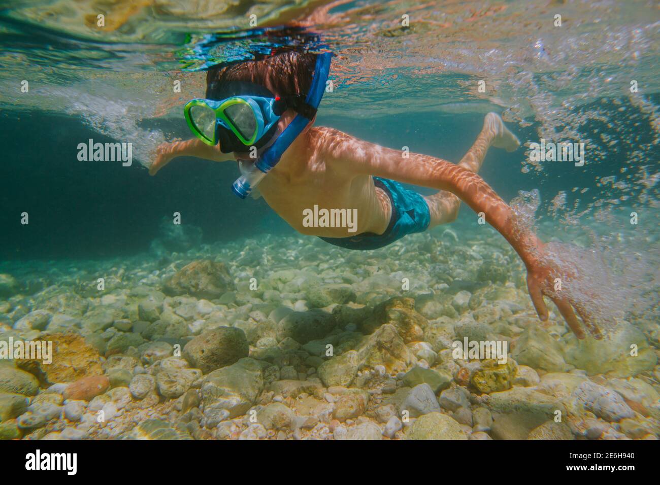 Child snorkeling. Young boy wearing diving mask and snorkel learning to