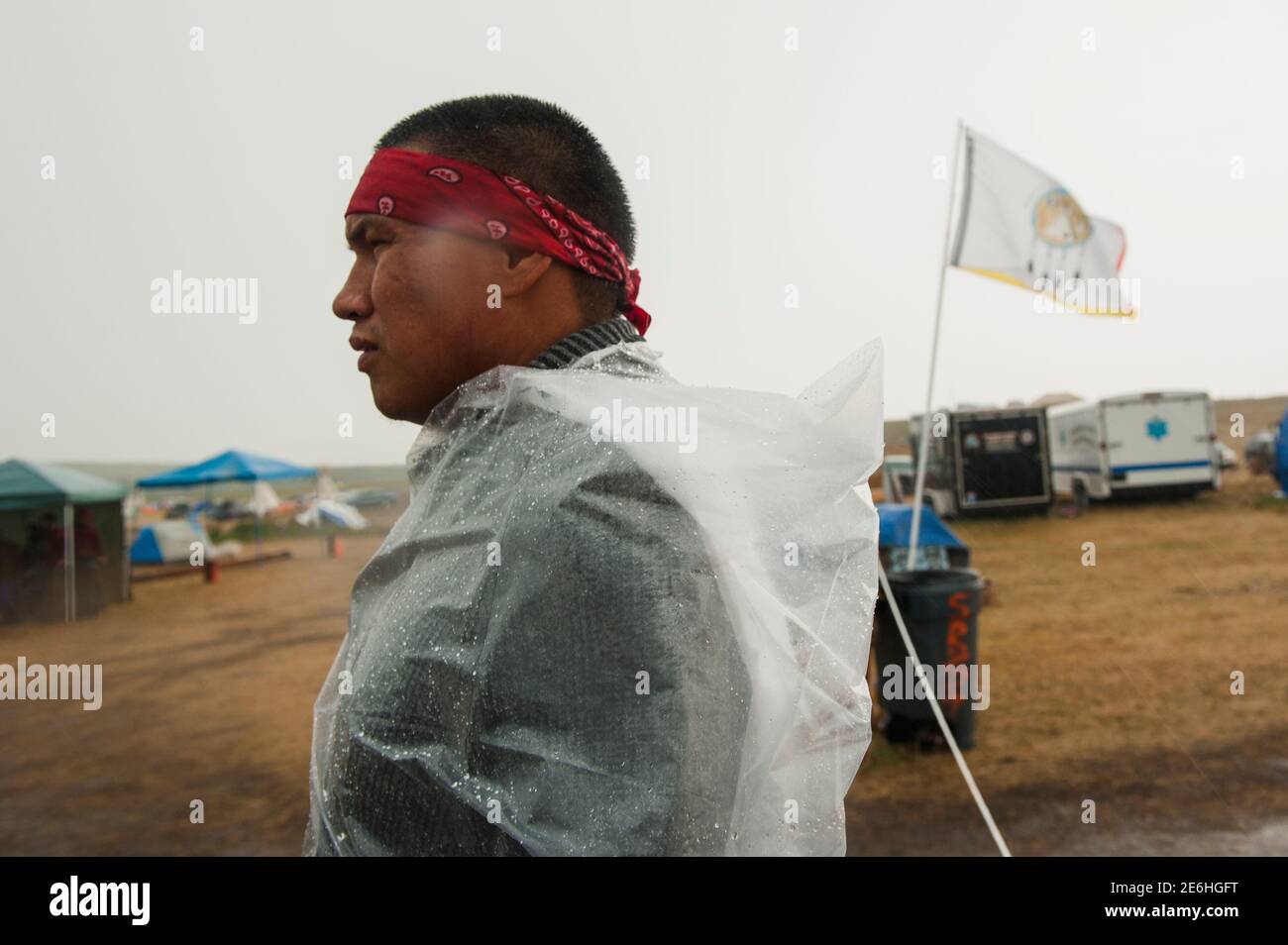 A member of the Seven Council camp security team, Miah, directs traffic through the camp during a heavy downpour at an encampment where hundreds of protestors have gathered on the banks of the Cannon Ball River to stop construction of the Energy Transfer Partners' Dakota Access oil pipeline near the Standing Rock Sioux reservation in Cannon Ball, North Dakota, U.S. September 7, 2016. Miah is a member of the Standing Rock Sioux tribe.   REUTERS/Andrew Cullen Stock Photo