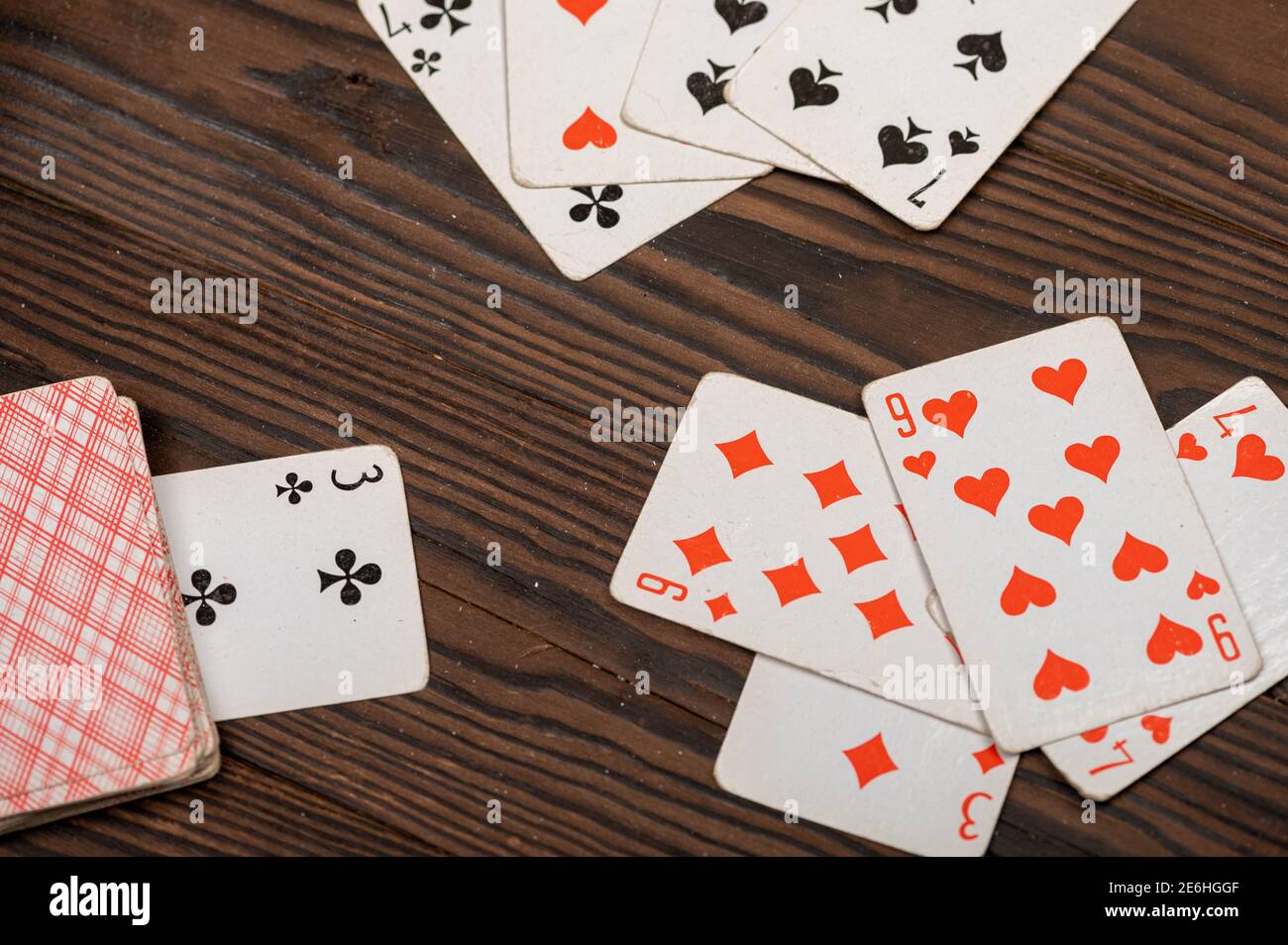 Playing cards on a wooden table. Close-up, selective focus. Stock Photo