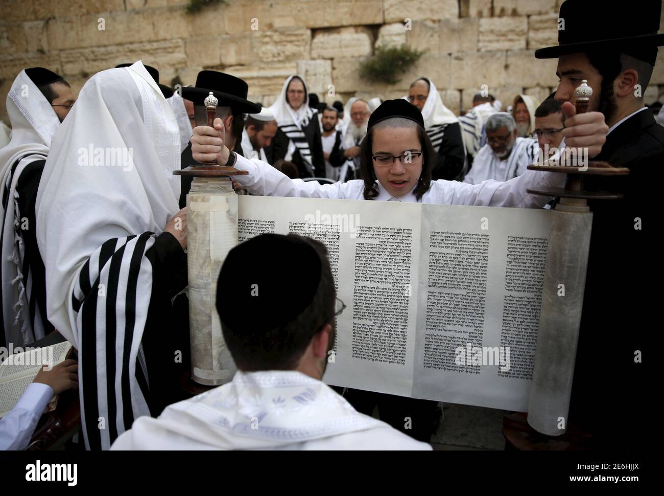 An UltraOrthodox Jewish boy holds a Torah scroll during a special