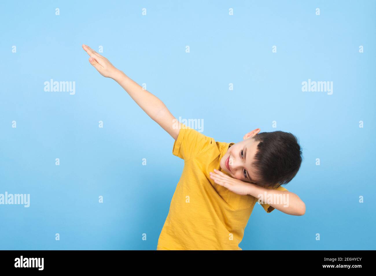 a child celebrates victory with a hand gesture to the sky Stock Photo