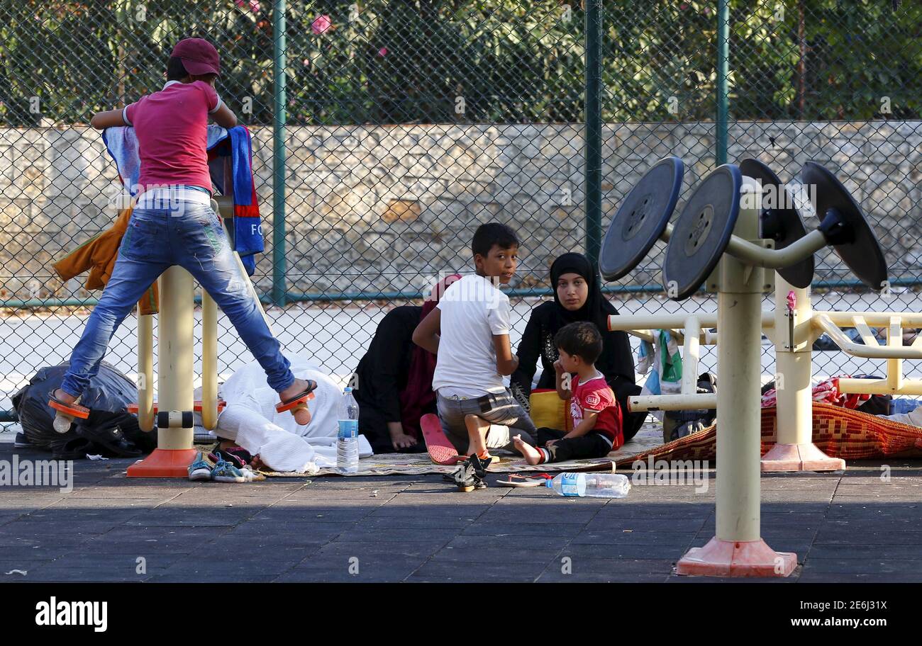 A Syrian family takes shelter at a playground in the resort town of Bodrum, Turkey, September 4, 2015. Turkish authorities stopped 57 people trying to cross to the Greek island of Kos