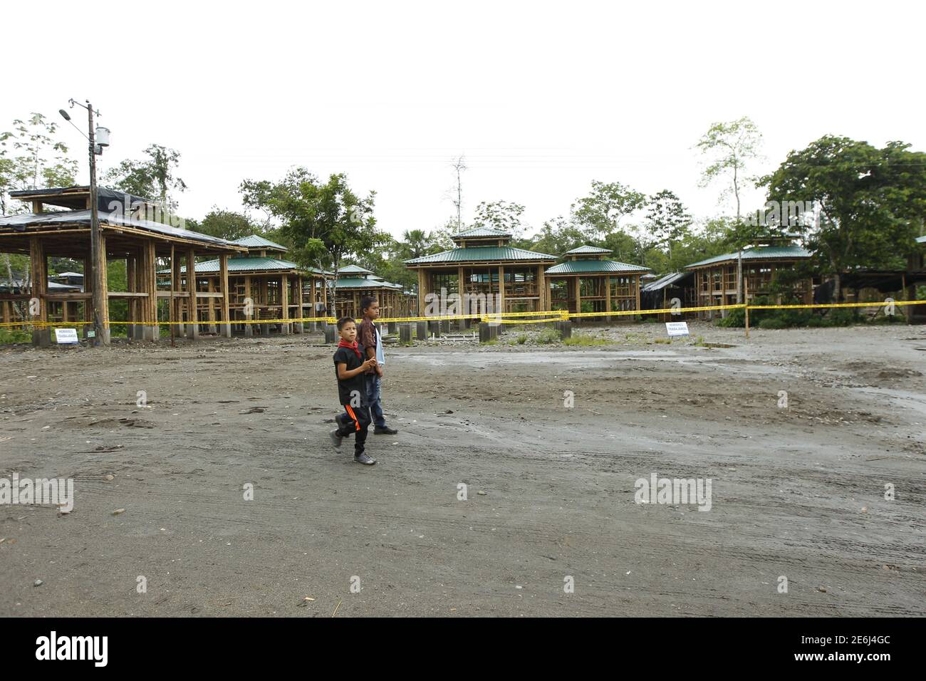 Boys of the Cofan indigenous people walk near new houses constructed by the government administration in the Quichua community at Dureno, Ecuador, March 26, 2016. REUTERS/Guillermo Granja Stock Photo