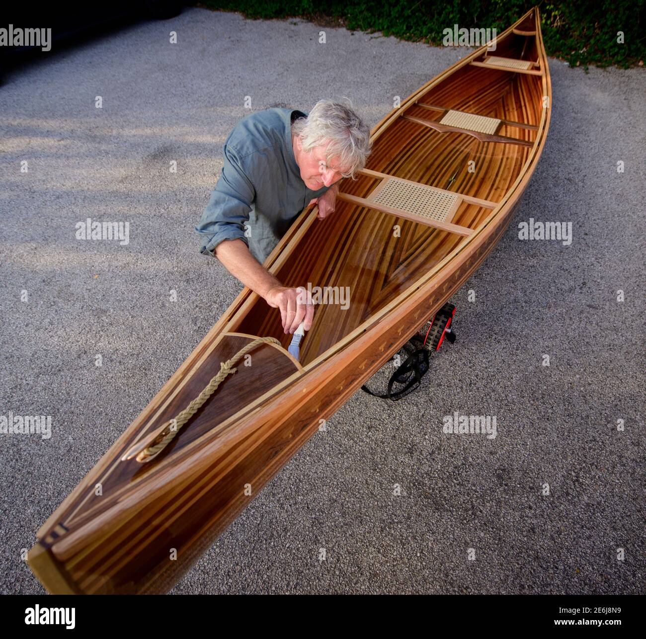 Boatbuilder Huw Edwards-Jones with his handmade Canadian canoe at Cuckmere, East Sussex, UK Stock Photo