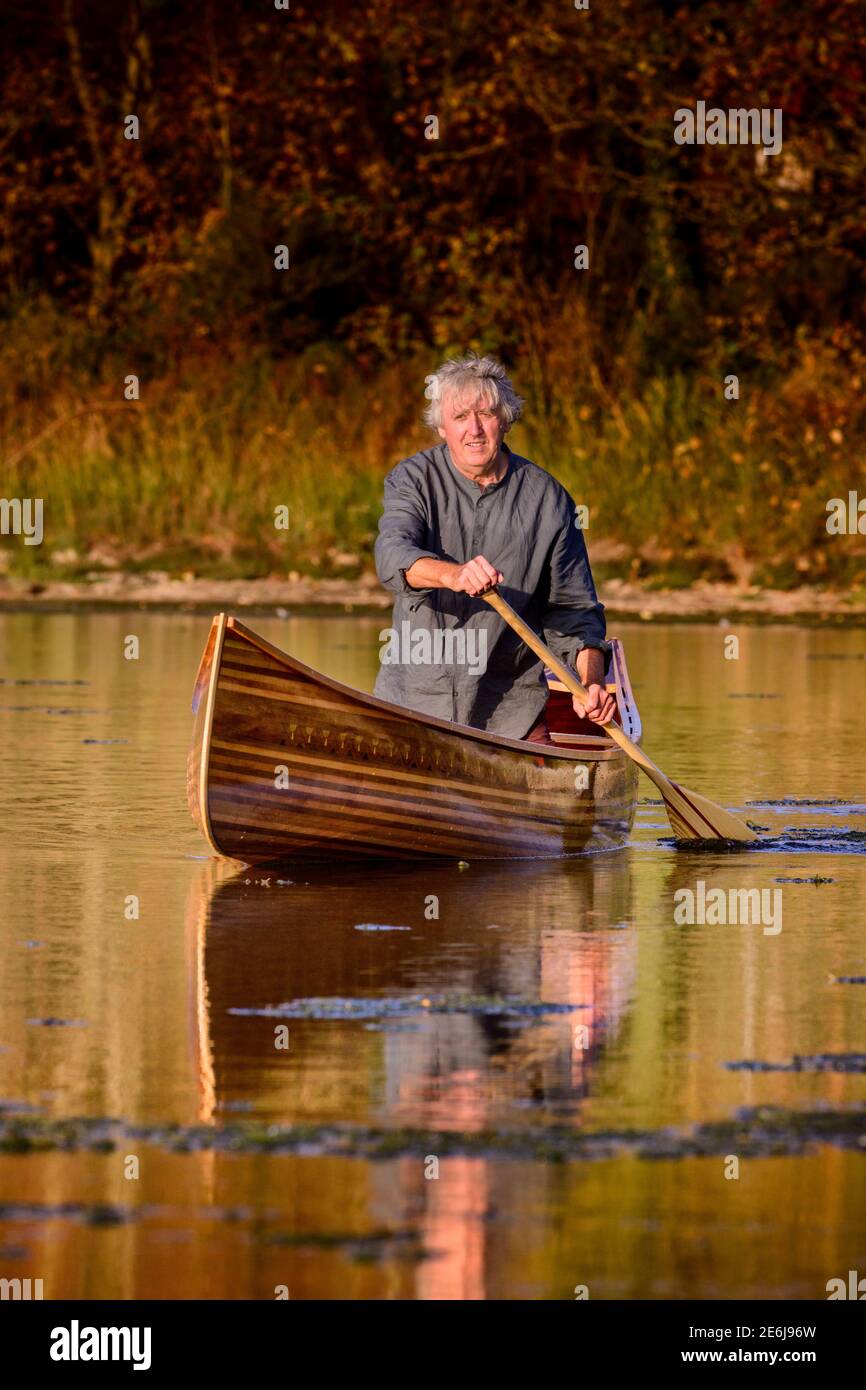Boatbuilder Huw Edwards-Jones with his handmade Canadian canoe at Cuckmere, East Sussex, UK Stock Photo