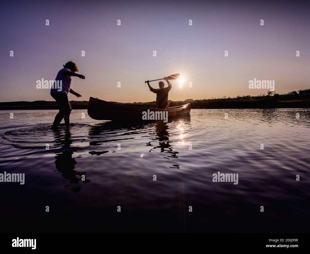 Boatbuilder Huw Edwards-Jones with his handmade Canadian canoe at Cuckmere, East Sussex, UK Stock Photo