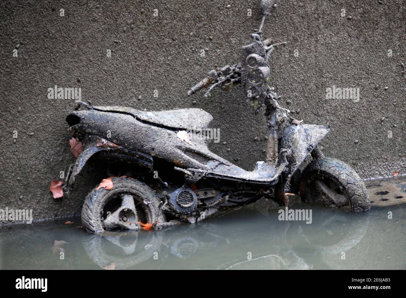 An abandoned mud covered scooter is seen during the draining of the Canal  Saint-Martin in Paris, France, January 5, 2016. Authorities start a  three-month cleanup operation of the canal St-Martin, in north-eastern