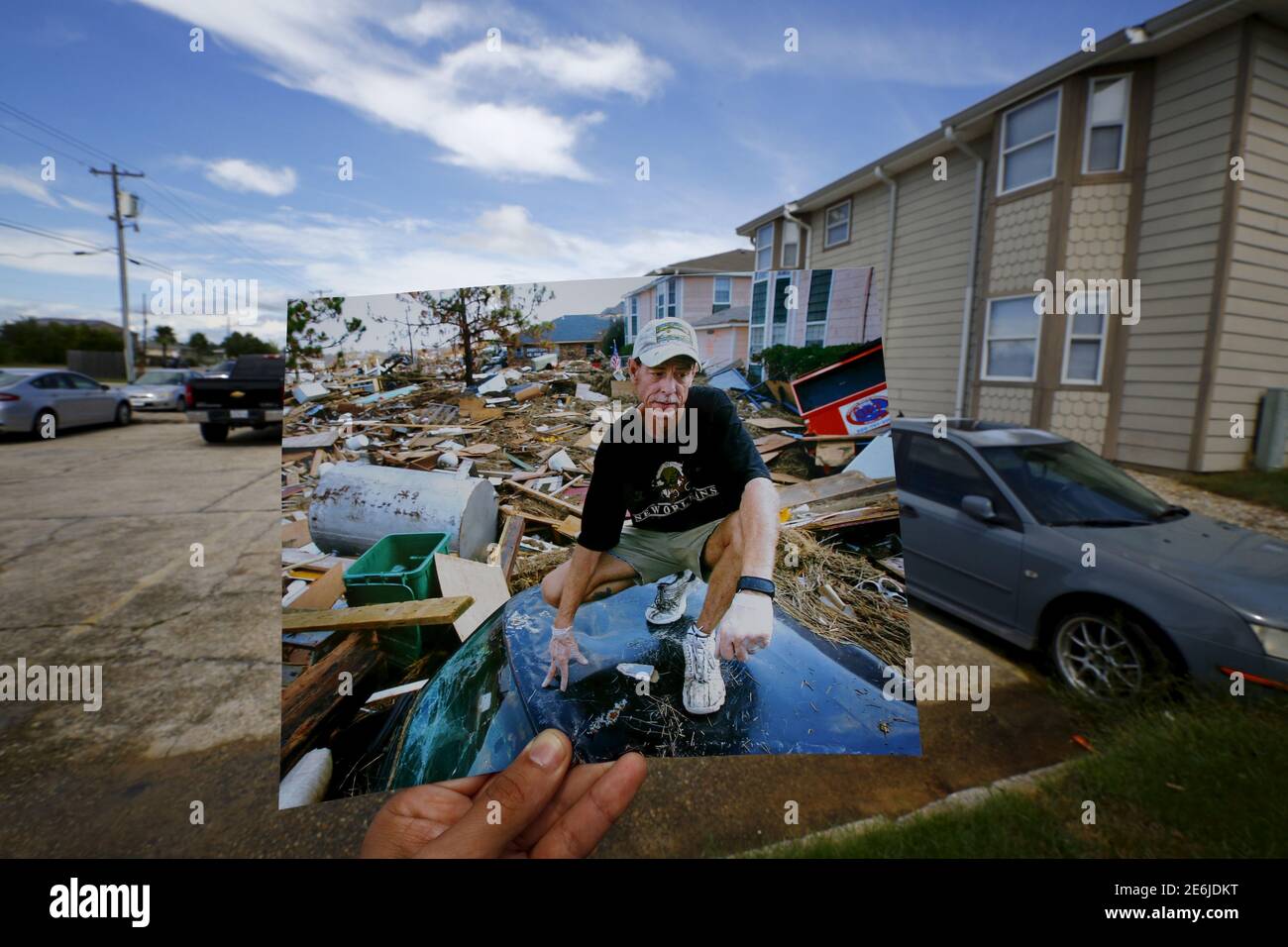 Photographer Carlos Barria holds a print of a photograph he took in 2005, as he matches it up at the same location 10 years on, in North Shore, northwest of New Orleans, United States, August 17, 2015. The print shows Michael Rehage squatting on the roof of his car, September 12, 2005, after Hurricane Katrina struck. In 2005, Hurricane Katrina triggered floods that inundated New Orleans and killed more than 1,500 people as storm waters overwhelmed levees and broke through floodwalls. Congress authorised spending more than $14 billion to beef up the city's flood protection after Katrina and bui Stock Photo