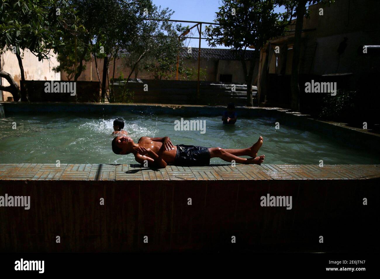 Boys swim to cool down from heat inside 