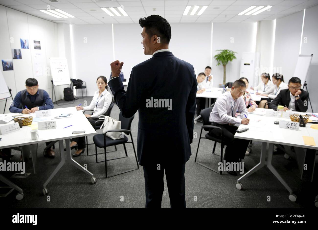 Trainer Lee Yida gives a lecture to dealership sales staffs during a sales  camp at BMW Group Training Center in Beijing, China, September 9, 2015. At  BMW, where deliveries to dealers in