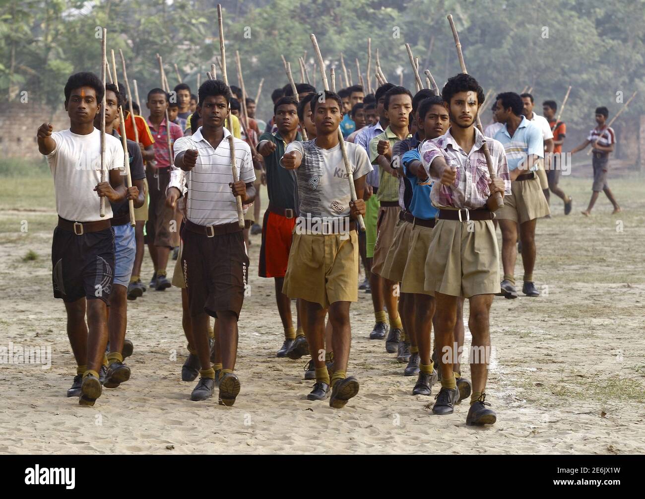 Volunteers Of The Hindu Nationalist Organisation Rashtriya Swayamsevak Sangh Rss Hold Sticks As They March During A Training Session At Tatiberia Village In West Bengal India In This May 20 2015 File